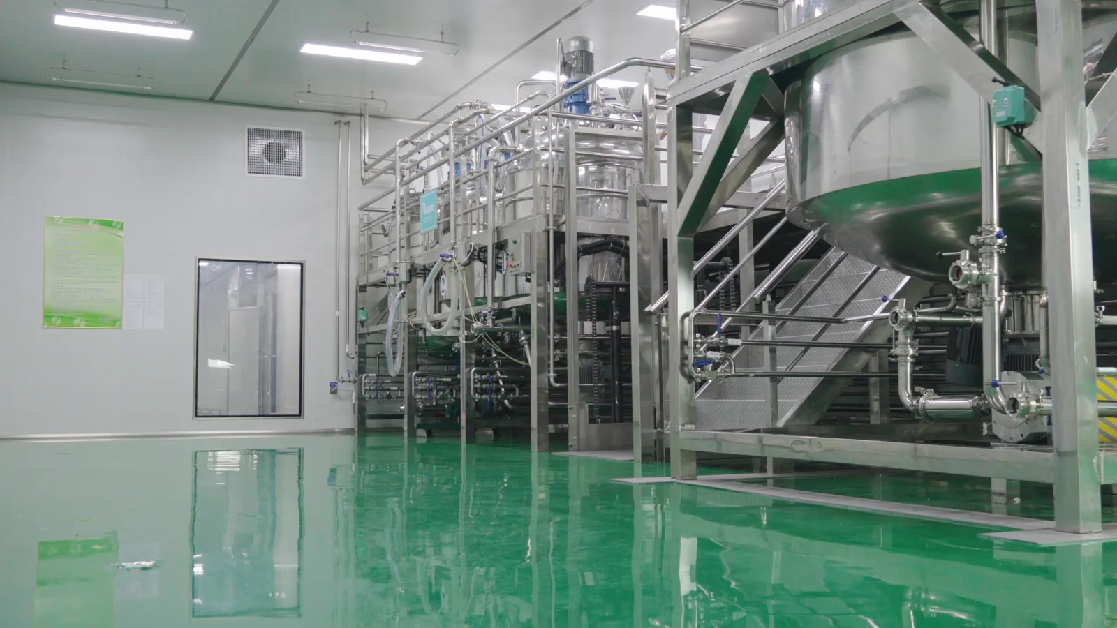 Stainless-steel emulsification and mixing vessels in the production workshop.