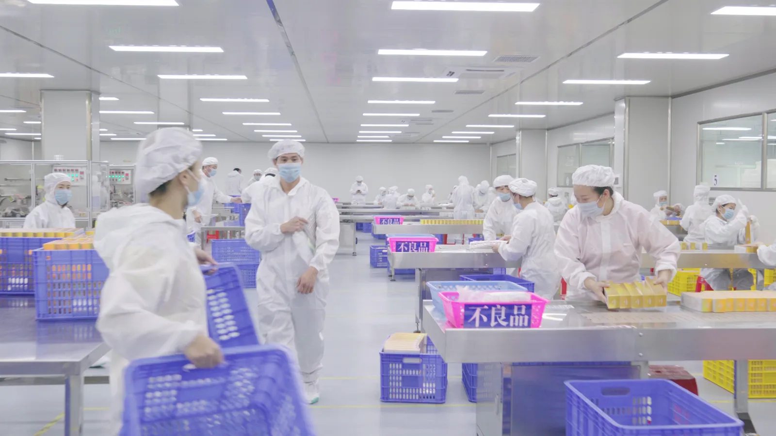 Overview of the packaging workshop with staff at several workstations.