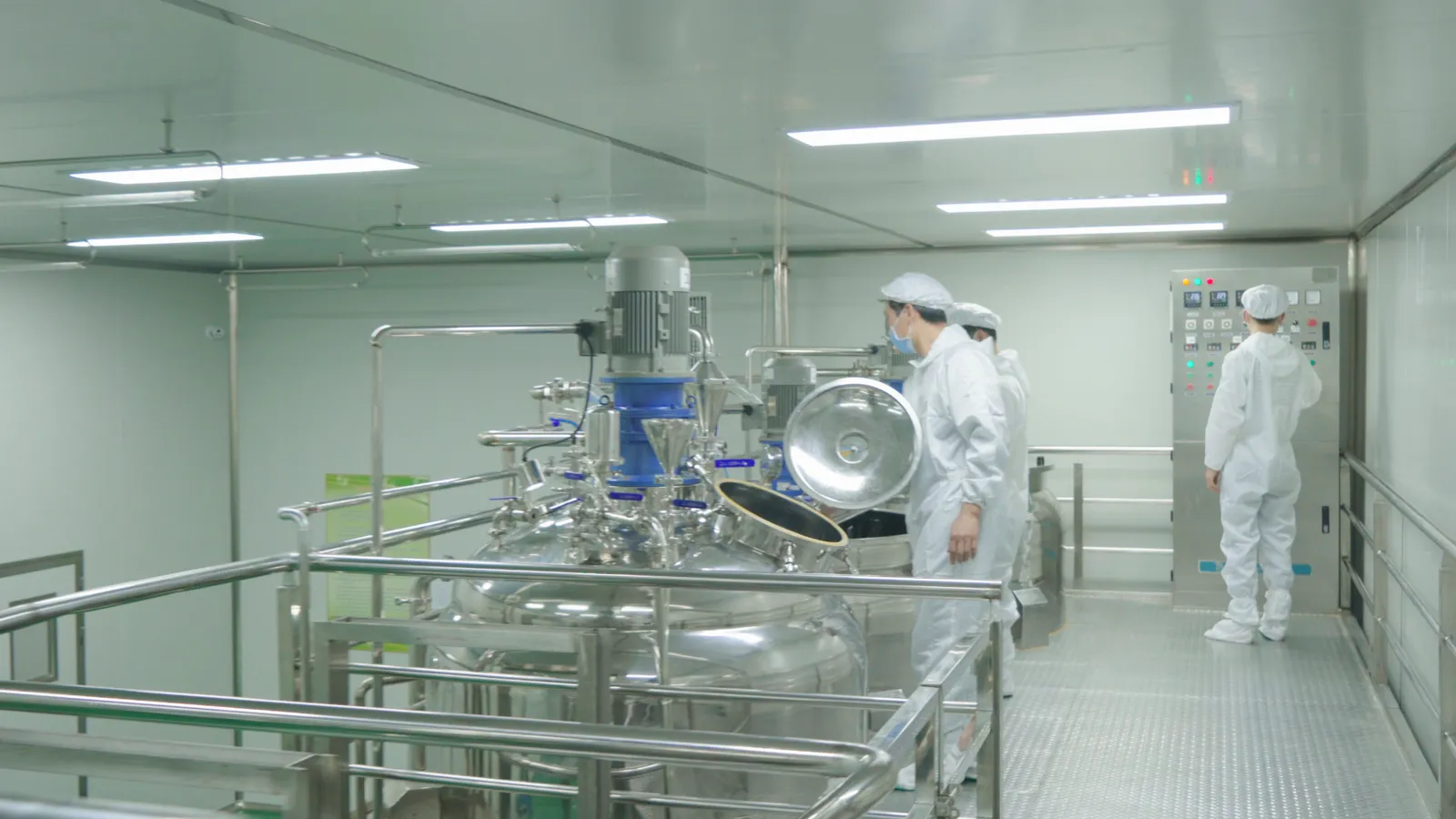 Production team operating manufacturing equipment in the workshop.